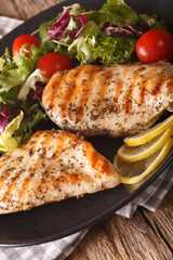 Grilled chicken breast with mixed salad close-up. Vertical