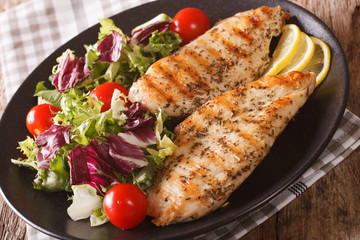 Grilled chicken breast with mixed salad close-up. horizontal