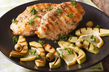 Grilled chicken breast with avocado, lemon and olive close-up. horizontal