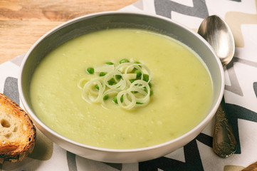 Vegetarian cream soup with leek, potatoes and green pea.