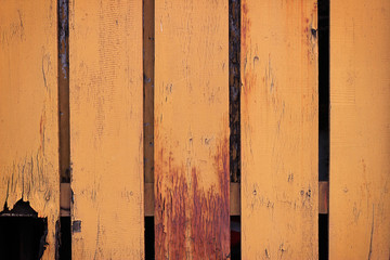 Surface and texture of fence, yellow color old wood painted for background