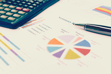 Data analyzing with calculator and pen. from charts and graph to