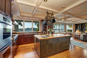Large kitchen island with hanging pot rack above
