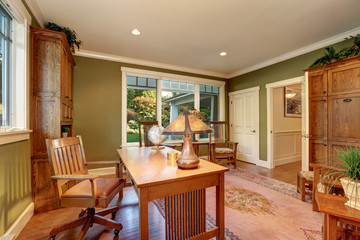 Large home office interior with green olive walls