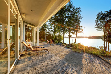 Large stone floor patio area of waterfront house