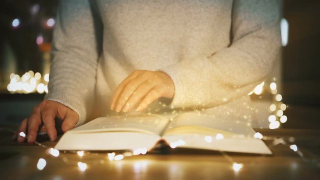 woman is reading a magical book. christmas concept