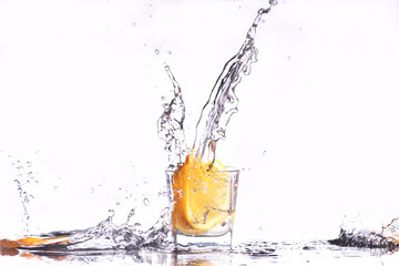 oranges splashing into martini glass