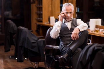 Senior business sitting man talking on mobile phone