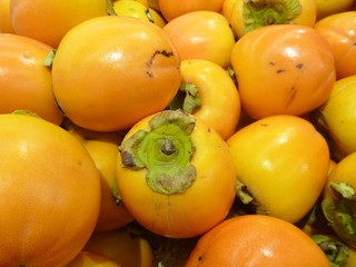 orange ripe kaki fruit in the market