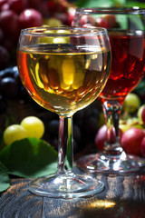 wine glasses on a dark wooden background, vertical, closeup
