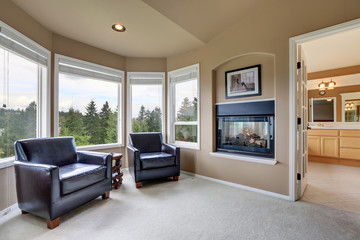 Interior of cozy sitting area with fireplace in the bedroom