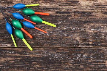 Fishing floats on wooden background © Elena Milevska