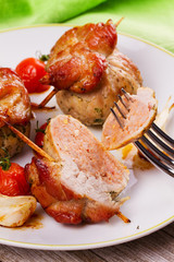 Meat rolls on scewers with cherry tomatoes and garlic