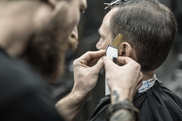 Doing haircut in barbershop - obrazy, fototapety, plakaty