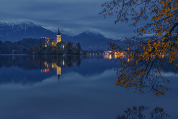 Bled lake and pilgrimage church at twilight reflected in water