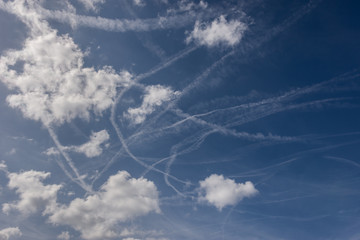 mix of chaotic jet steam and clouds in the sky