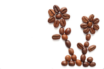 Coffee beans arranged two flowers on a white background