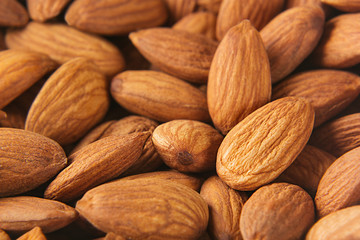 Almonds background. Pile of selected almonds close-up. For vegetarians.