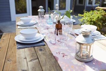 Table Set For Outdoor Meal On Wooden Table In Garden