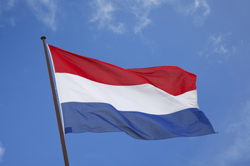 Fototapeta na wymiar Dutch flag in a blue sky