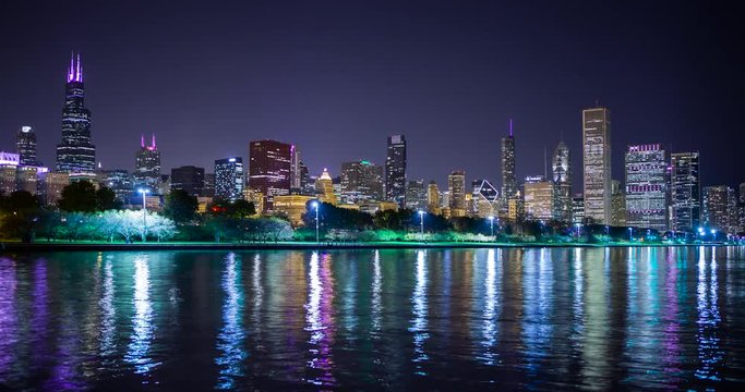 Chicago, Illinois, USA - view from the Lakefront Trail at the Field Museum / Shedd Aquarium facing north at shore of Lake Michigan and the skyline at night - Timelapse without motion 