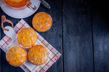 Aromatic Homemade Lemon and Poppy seed Muffins wooden background. Top view with copy space
