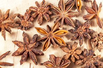 Stars of dried anise (Illicium verum)  on  wooden plank.