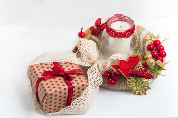 Christmas wreath with a gift box and candle 