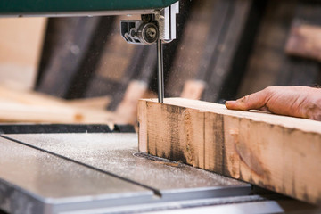 Man repairing restoring old wooden fishing boat. Large ocean boat. Traditional Scandinavian wooden ships. ship repair workshop. A man grinds wooden beams.