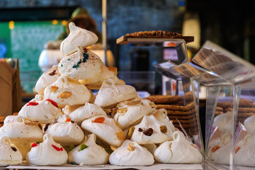 Meringues on display on a confectionery stall at Borough Market in London