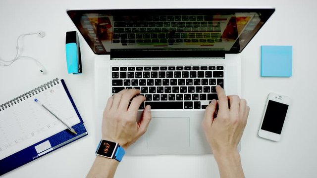 top view of a man closing a laptop