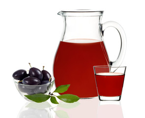 plum juice in a glass and carafe on a white background