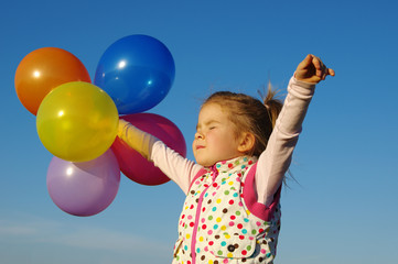  girl outdoors with balloons