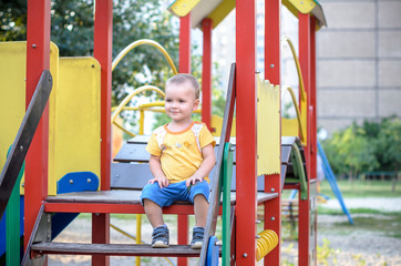 Cute kid climbing upstairs on playground