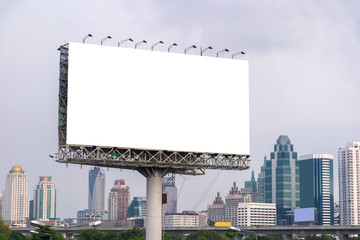 large blank billboard on road with city view background