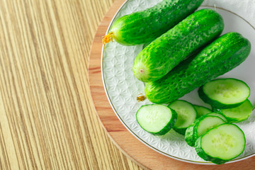  cucumbers on wooden background