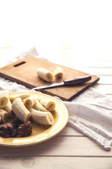 Sliced bananas and figs on a wooden table. Healthy food. Organic