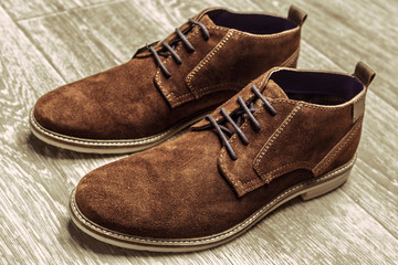 Fashion concept with male shoes on wooden background