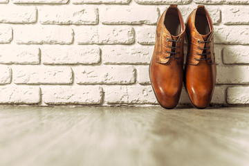Fashion concept with male shoes on wooden background