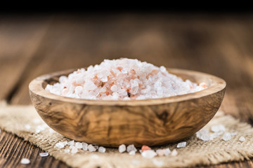 Portion of Himalayan Salt on wooden background (selective focus)