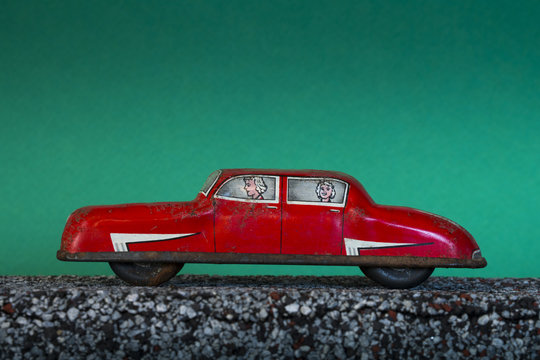 Vintage toy car on green background