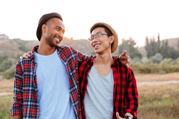 Two cheerful asian and african american young friends