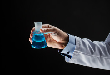 close up of scientist holding flask with chemical