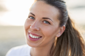 close up of happy smiling young woman face