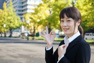 Young business woman saying OK