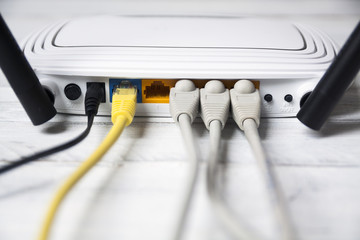 Network cables connected to router, close-up.