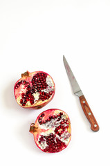 Pomegranate fruit and seeds on white background