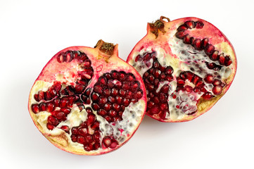 Pomegranate fruit and seeds on white background