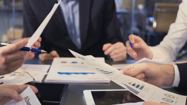 Business people exchanging documents, closeup shot