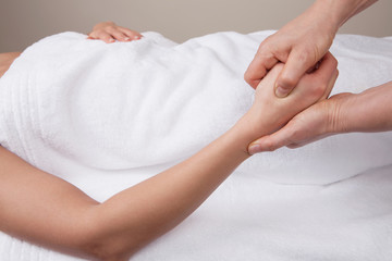 Fototapeta na wymiar Therapist doing pressure point massage on a woman's hand